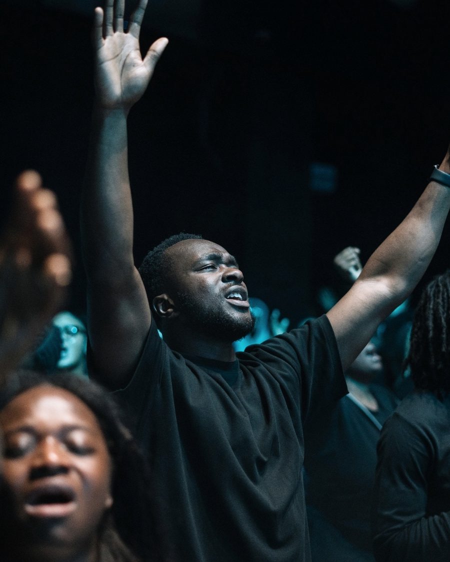 Hands raised during corporate worship at a KAC gathering.