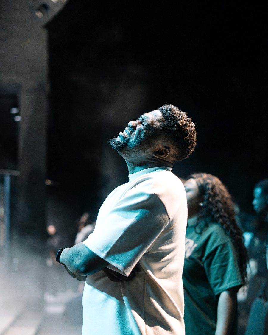 A young man in quiet posture during worship.