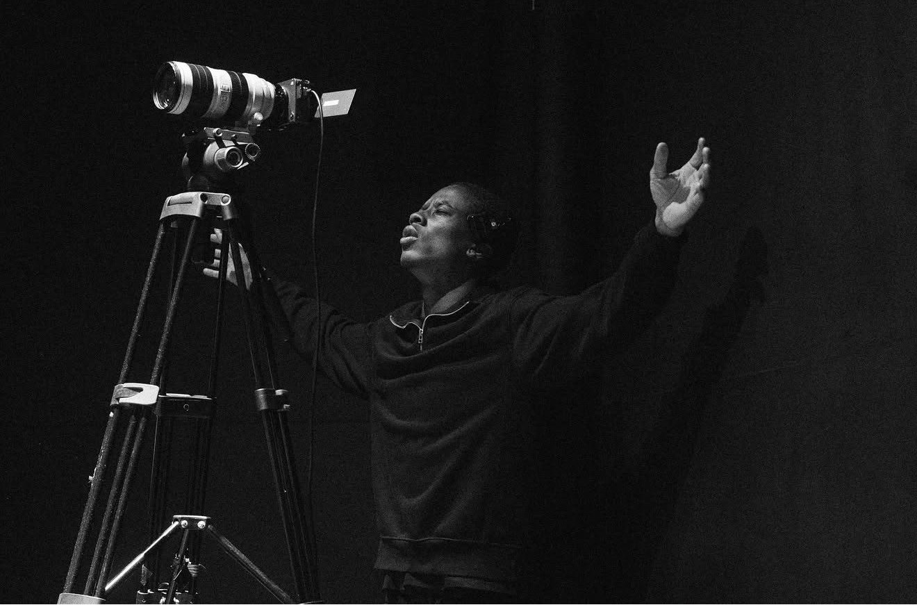 A camera operator working quietly during worship